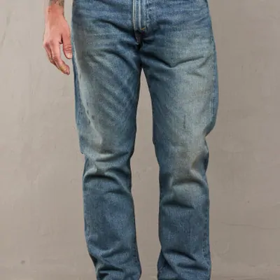 Light wash straight leg jeans worn by a model, framed from the waist to the ankle