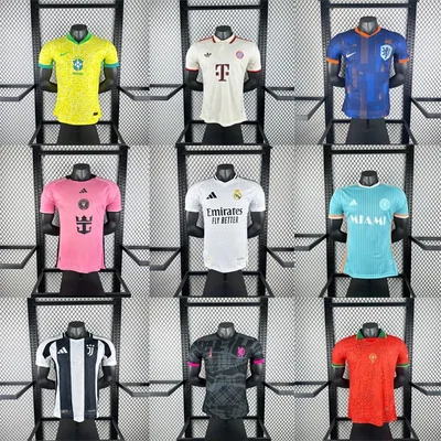 Nine football shirts in team colours hung in three rows on a black display rack