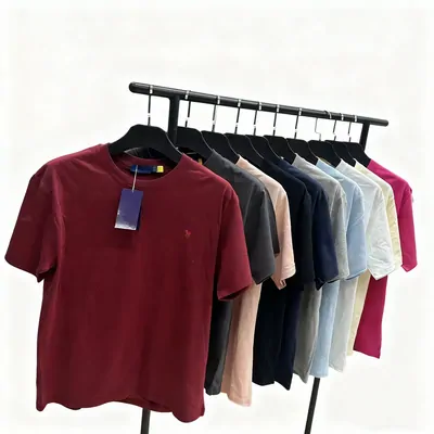 A rail of plain cotton tees in burgundy, navy, grey and olive, the burgundy one turned to the front